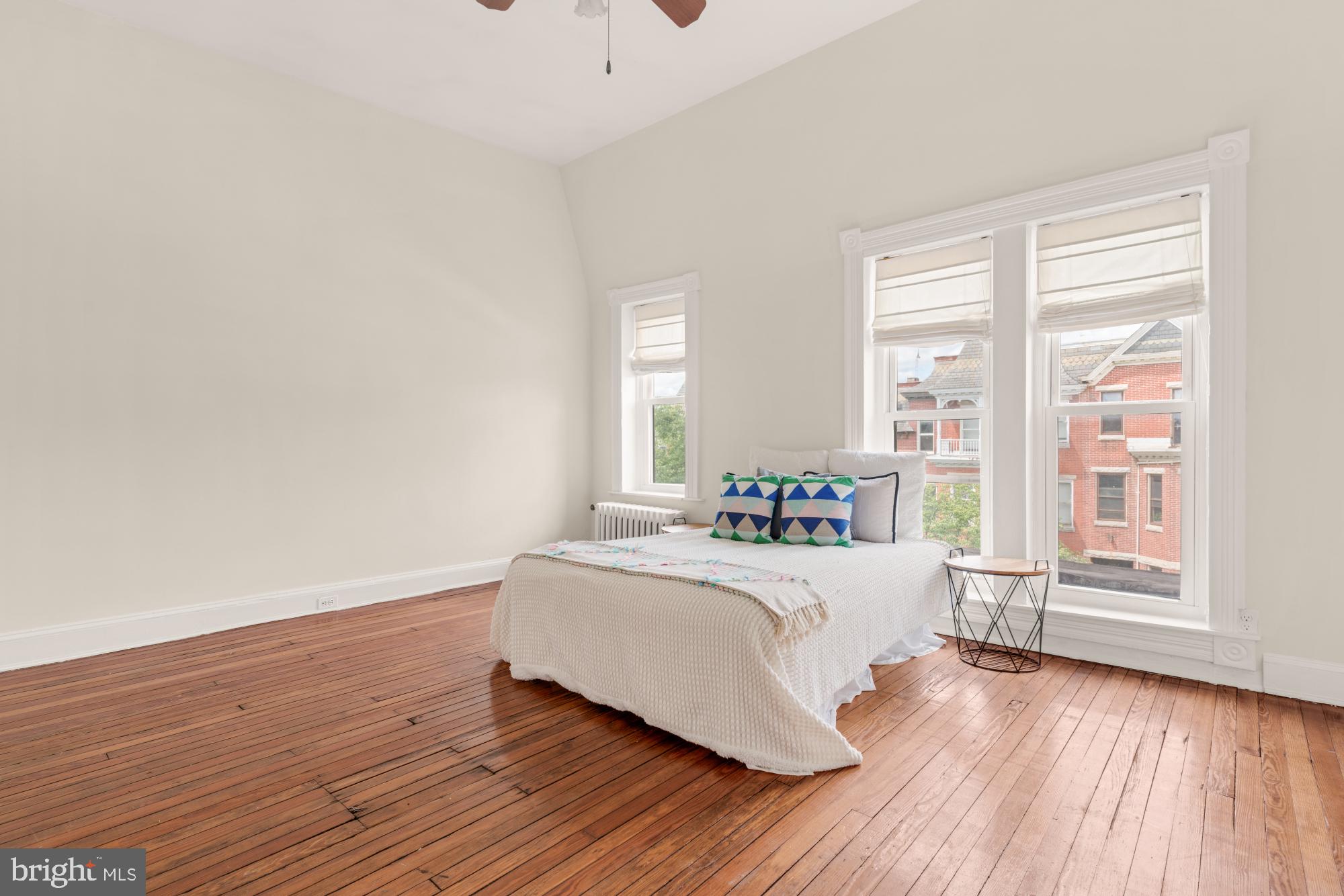 2133 Bolton Street Baltimore, MD 21217 - Photo 32 of 53 a bedroom with a bed and wooden floor