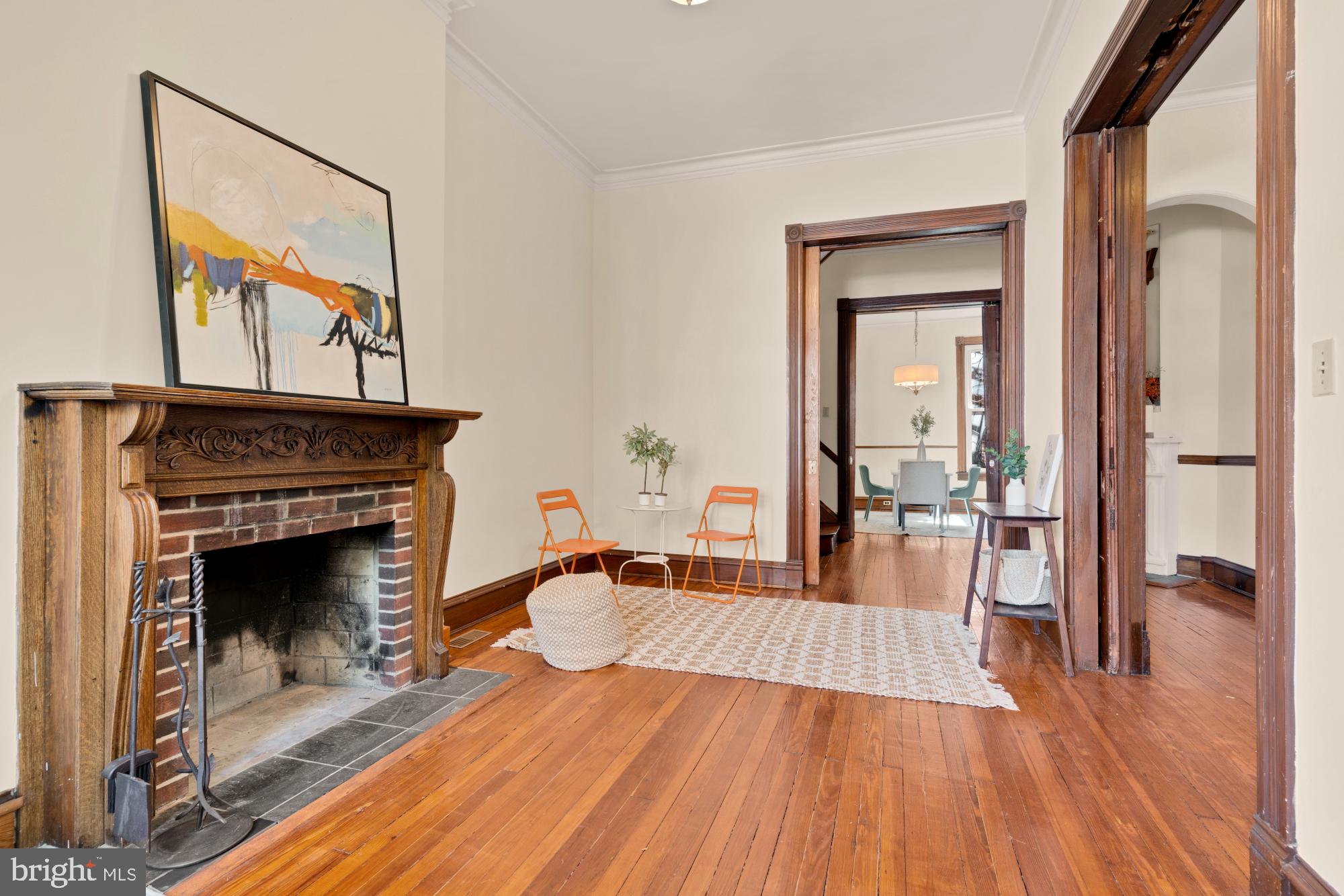 2133 Bolton Street Baltimore, MD 21217 - Photo 5 of 53 a livingroom with fireplace and wooden floor