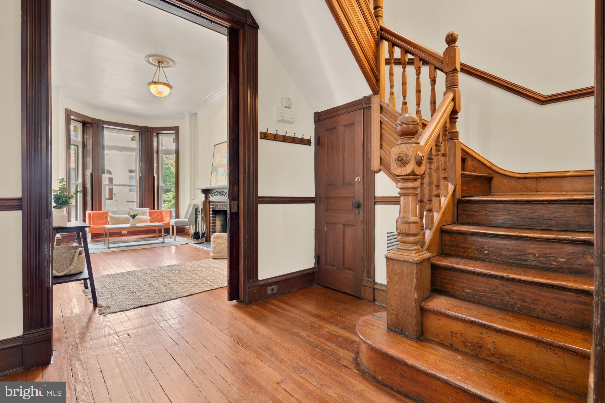 2133 Bolton Street Baltimore, MD 21217 - Photo 7 of 53 a view of staircase with wooden floor and a rug