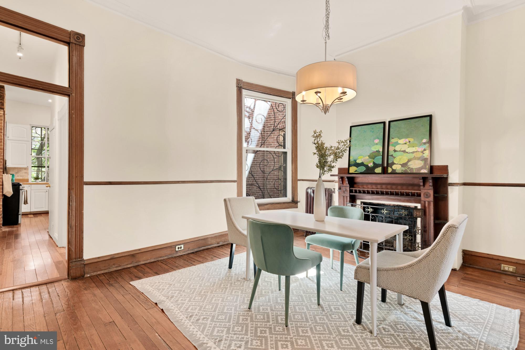 2133 Bolton Street Baltimore, MD 21217 - Photo 9 of 53 a dining room with furniture a chandelier and wooden floor