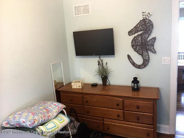 a bedroom with a bed and flat screen tv