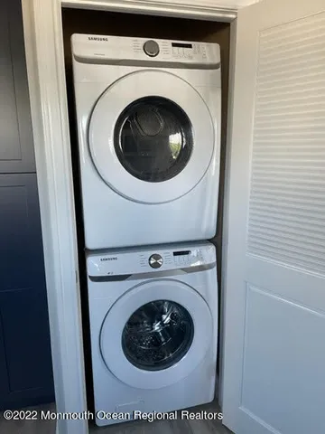 a view of a house with a window and wooden fence