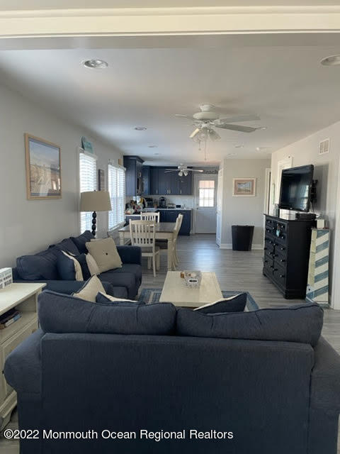 111 Guyer Avenue, Unit DOWN Lavallette, NJ 08735 - Photo 3 of 21 a living room with furniture and a flat screen tv