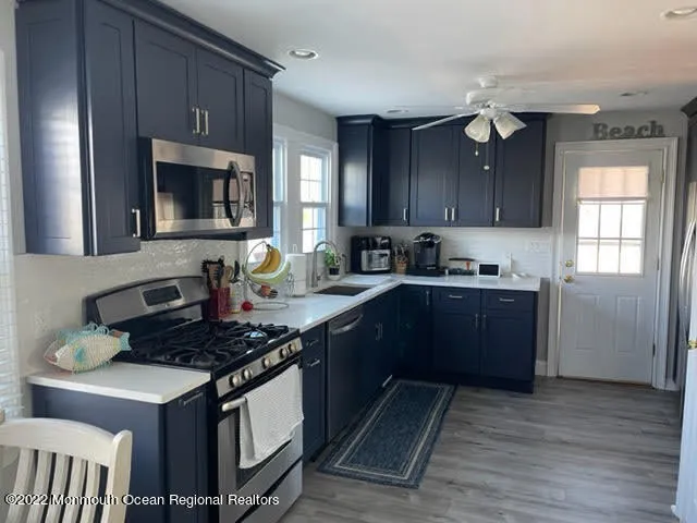 a kitchen with stainless steel appliances granite countertop a stove a sink dishwasher and a refrigerator