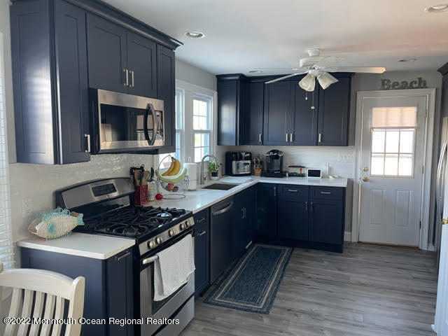 111 Guyer Avenue, Unit DOWN Lavallette, NJ 08735 - Photo 7 of 21 a kitchen with stainless steel appliances granite countertop a stove a sink dishwasher and a refrigerator