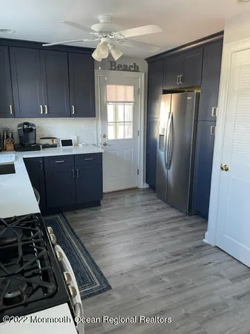a kitchen with granite countertop a stove and cabinets