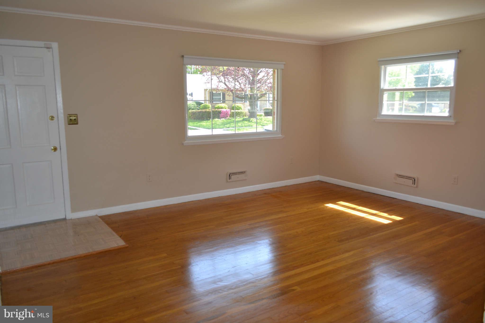 1406 Woodbridge Road Baltimore, MD 21228 - Photo 6 of 18 a view of empty room with wooden floor and fan