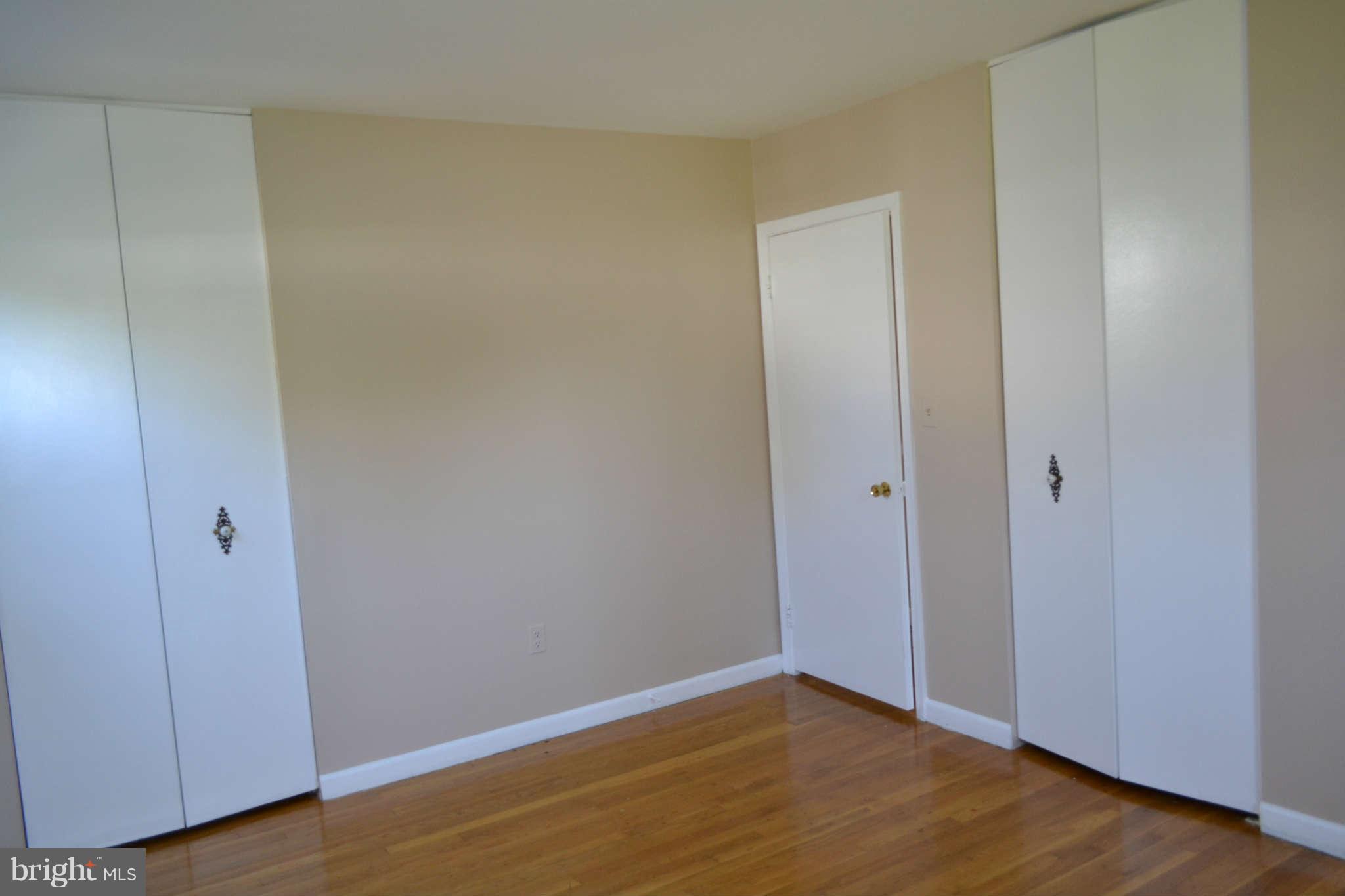 1406 Woodbridge Road Baltimore, MD 21228 - Photo 8 of 18 a view of an empty room with wooden floor