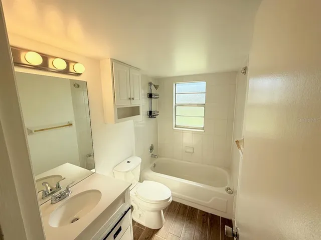 a view of swimming pool with lawn chairs and a yard