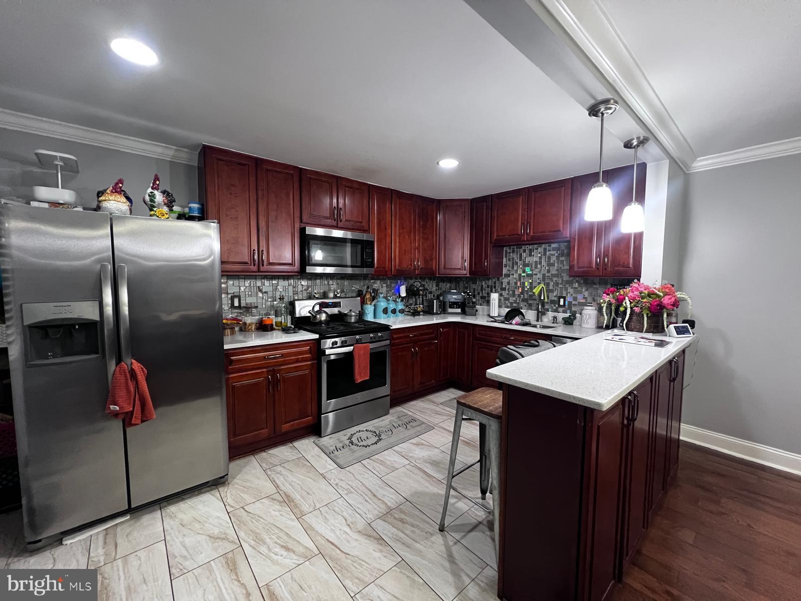 12715 Cabell Road Philadelphia, PA 19154 - Photo 22 of 31 Modern kitchen with rich wood cabinetry.