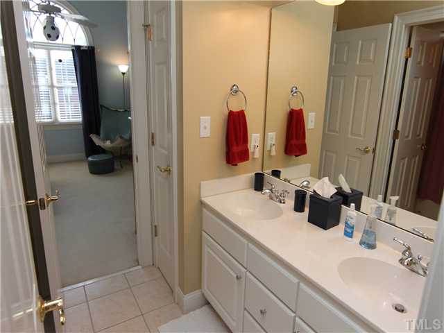 12501 Ribbongrass Court Raleigh, NC 27614 - Photo 22 of 25 "Jack and Jill" style bathroom sits between bedrooms. Shared dual vanities with private tub/shower.