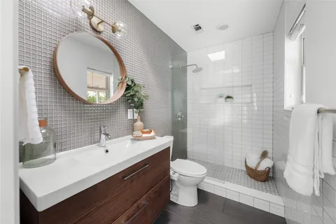 a bathroom with a toilet sink and mirror