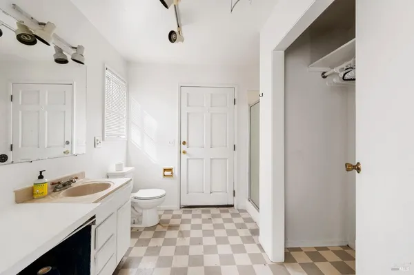 a view of a bedroom with window and hardwood floor