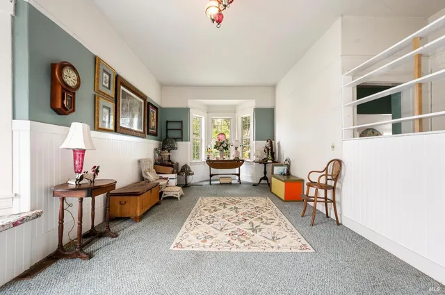 a living room with furniture rug and window