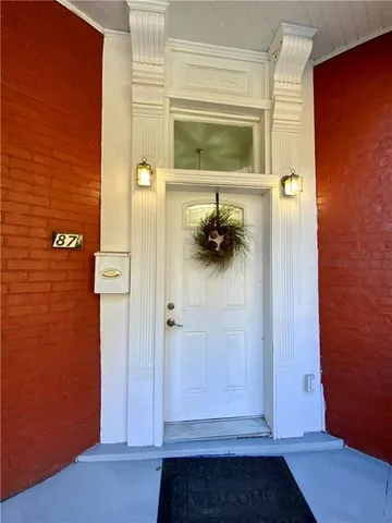 a view of front door of house with outdoor seating