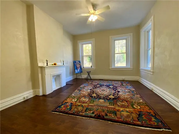 a view of a livingroom with a ceiling fan and window