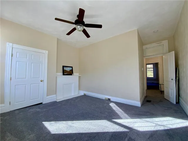 a view of staircase with white walls and a window