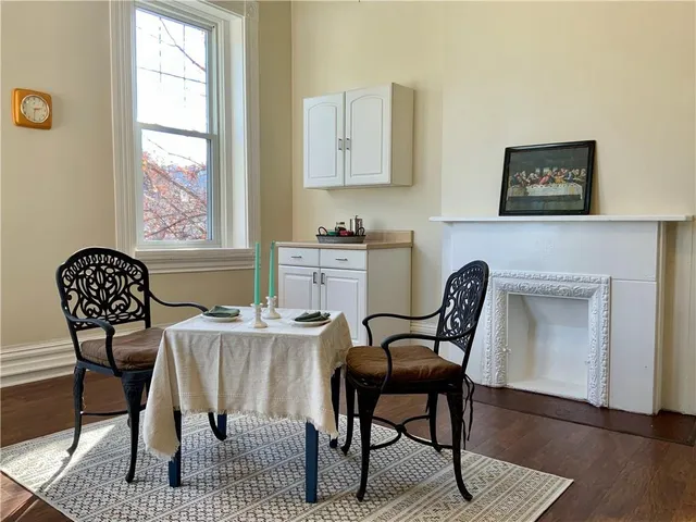 a living room with furniture a table and wooden floor