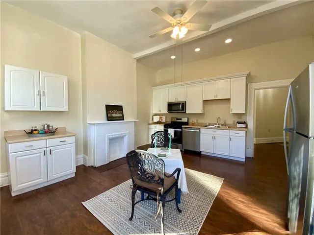 a kitchen with stainless steel appliances granite countertop a sink and a stove