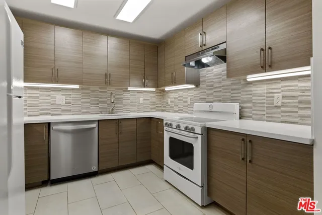 a kitchen with stainless steel appliances granite countertop a sink and cabinets