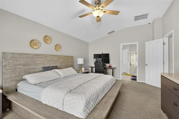 a bedroom with a bed and a chandelier