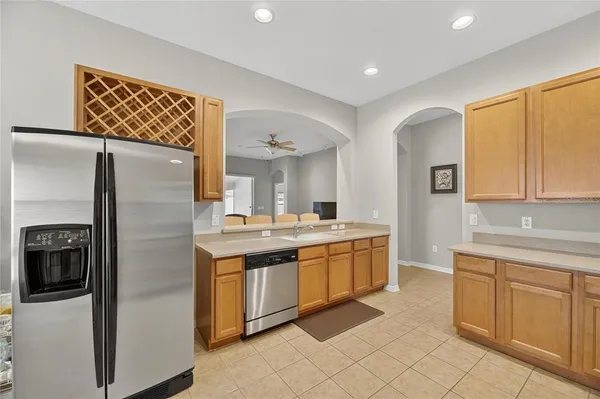 a kitchen with stainless steel appliances granite countertop a refrigerator and a sink