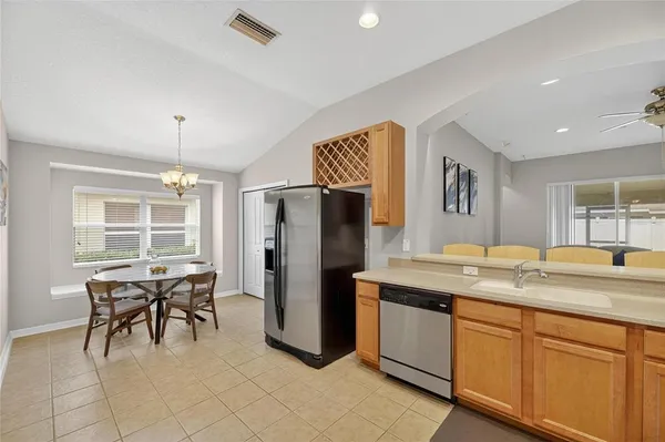 a kitchen with a refrigerator a table and chairs