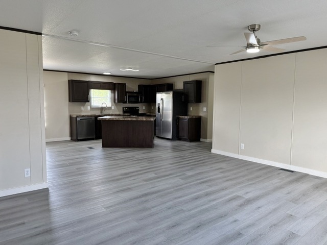 393 Duchess Pass Kyle, TX 78640 - Photo 14 of 14 An open floorplan combines a contemporary kitchen with abundant living space on vinyl flooring.