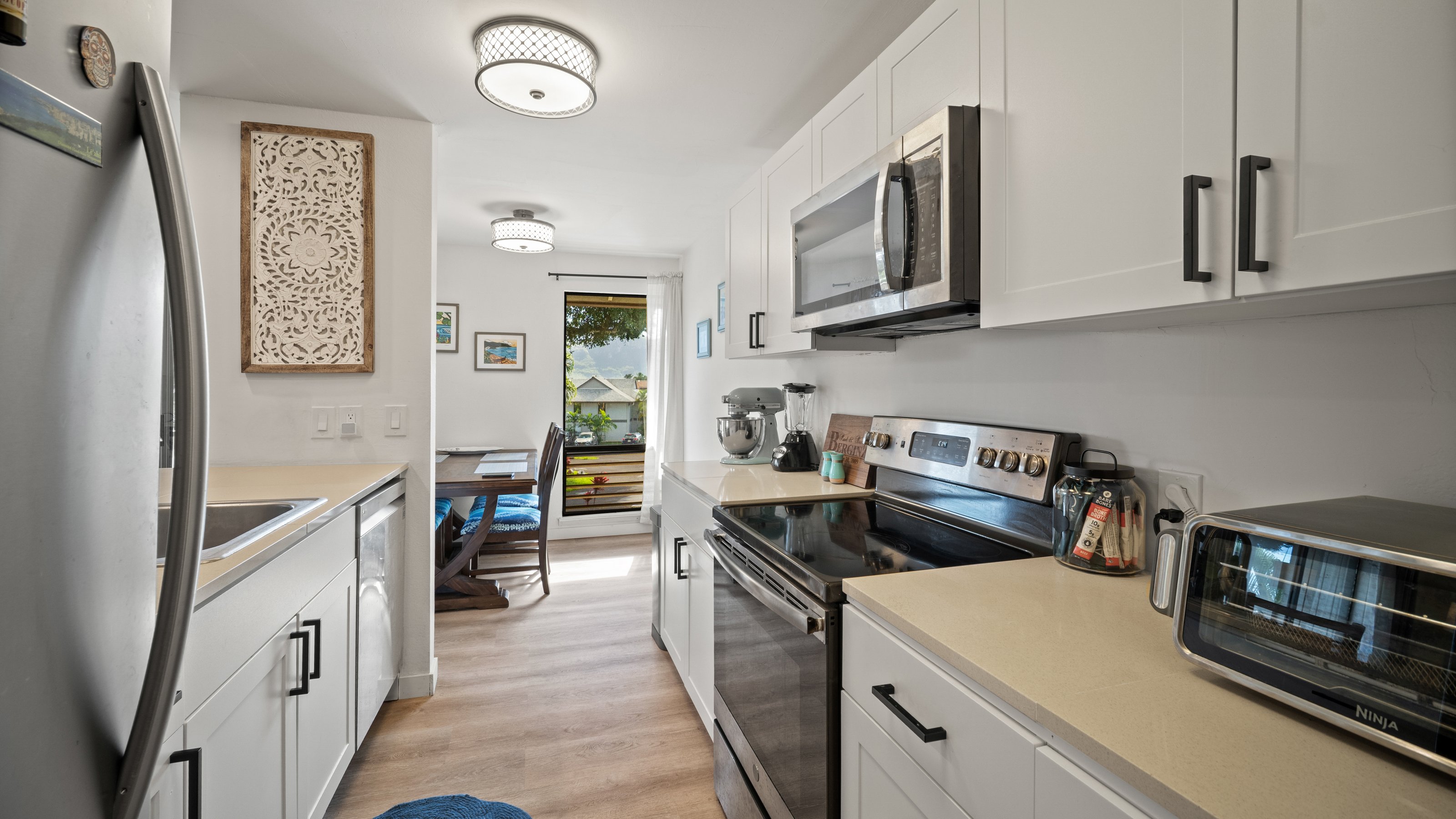 4121 Rice Street, Unit 2708 Lihue, HI 96766 - Photo 10 of 29 a kitchen with stainless steel appliances granite countertop a stove and a refrigerator