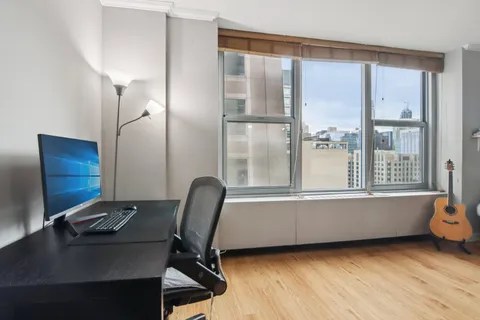 a view of workspace with wooden floor and windows
