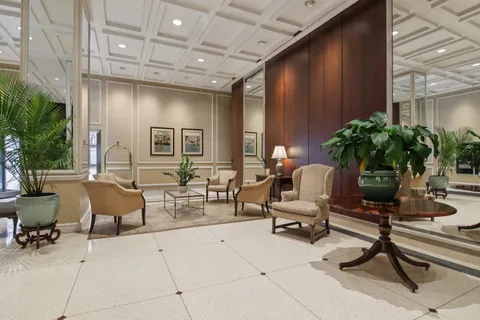 a building outdoor space with patio furniture and potted plants