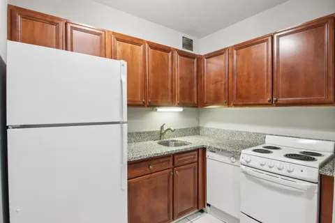 a white refrigerator freezer sitting inside of a kitchen