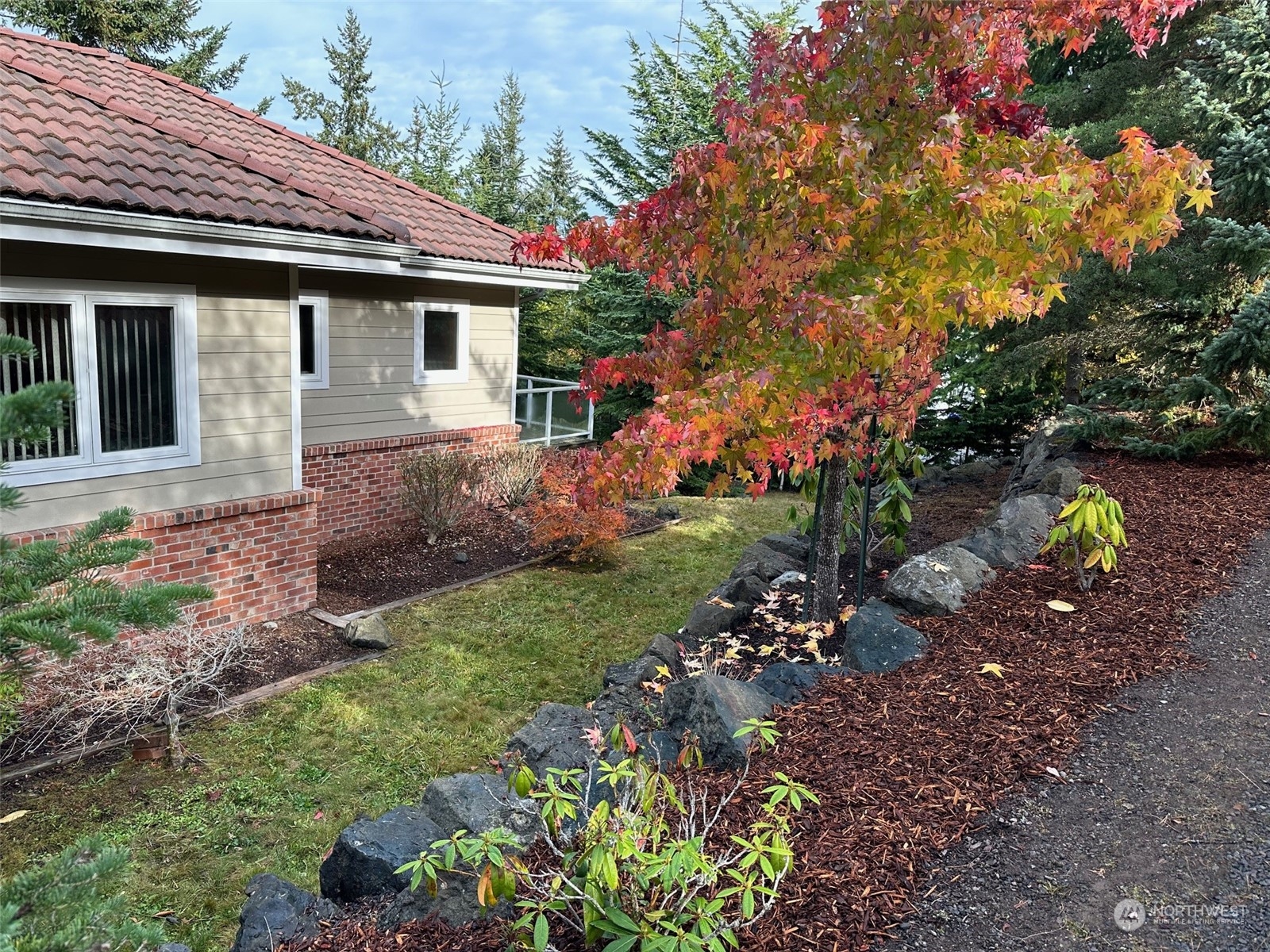 372 Owls Nest Road Sequim, WA 98382 - Photo 40 of 40 a front view of a house with a yard and a garden