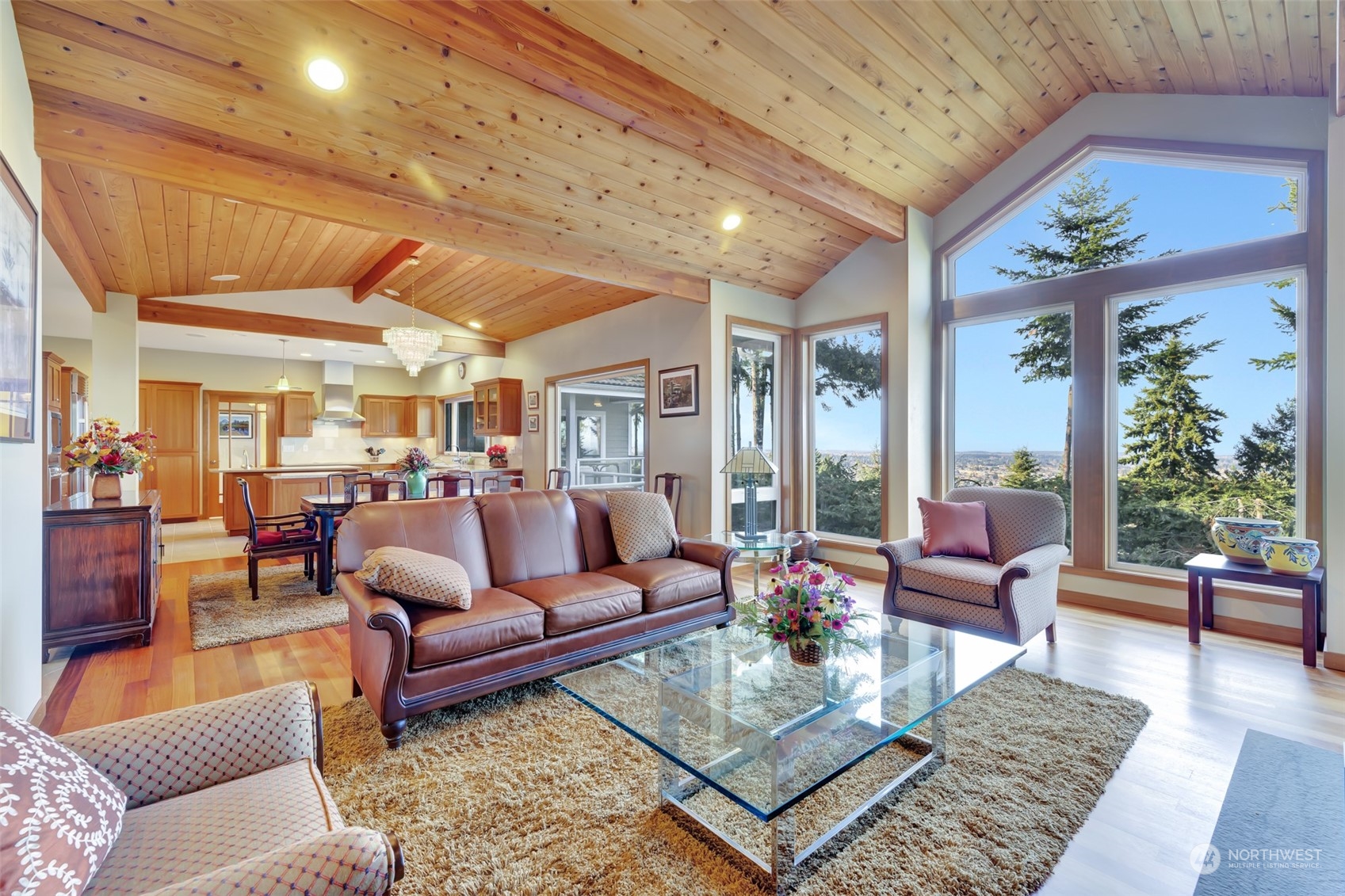 372 Owls Nest Road Sequim, WA 98382 - Photo 5 of 40 a living room with furniture large windows a rug and a potted plant