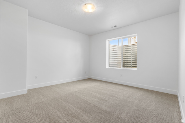 43 South Crimson Way, Unit 311 Mapleton, UT 84664 - Photo 22 of 28 Spacious room featuring neutral carpeting, white baseboards, and a window with a window well