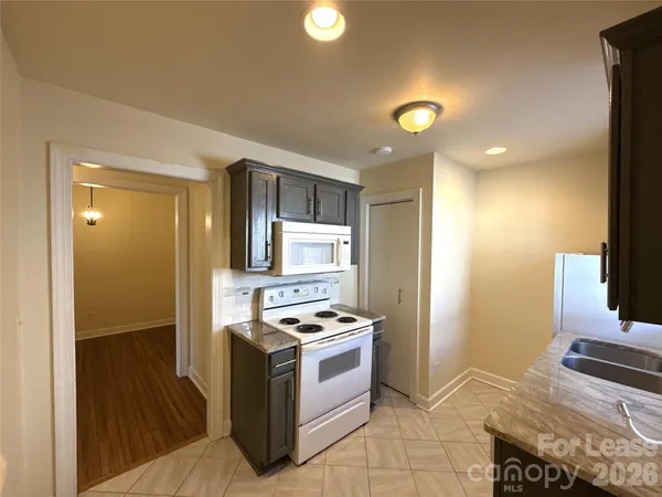 a kitchen with stainless steel appliances granite countertop a stove and a refrigerator