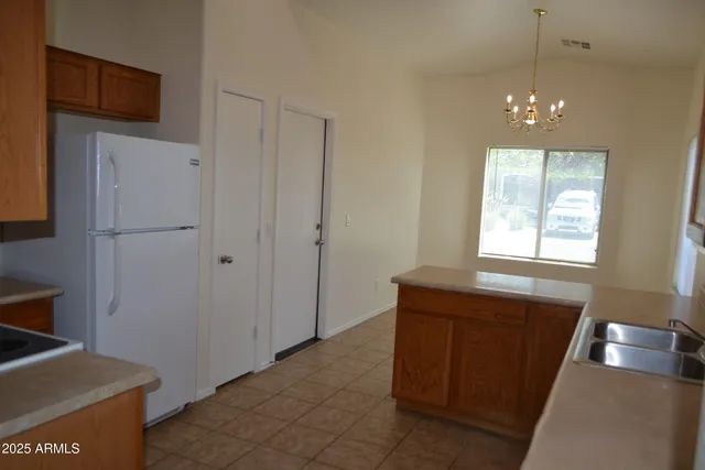 a kitchen with a sink cabinets and appliances