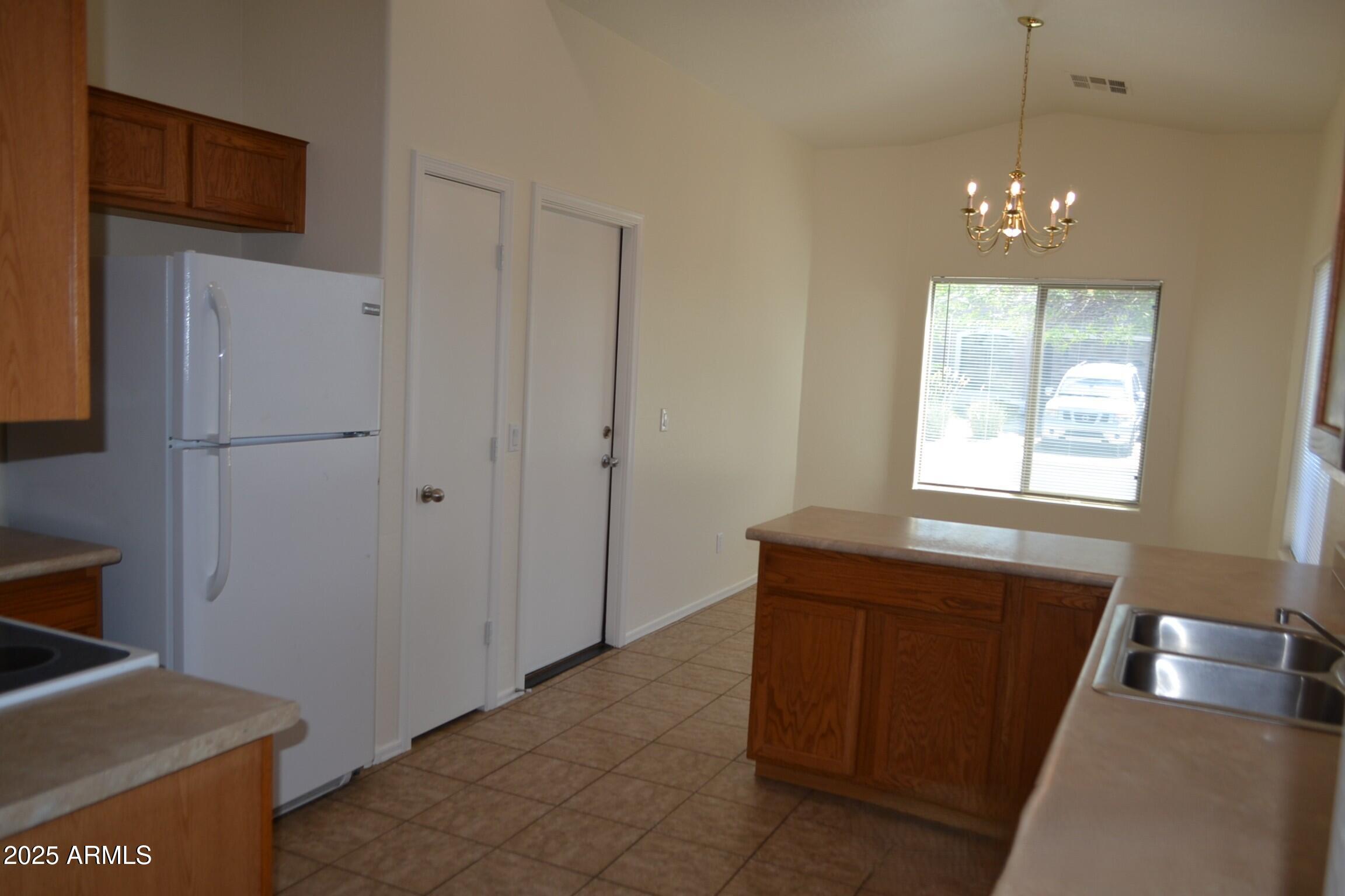 6746 East Superstition Way Florence, AZ 85132 - Photo 4 of 19 a room with chandelier fan and windows