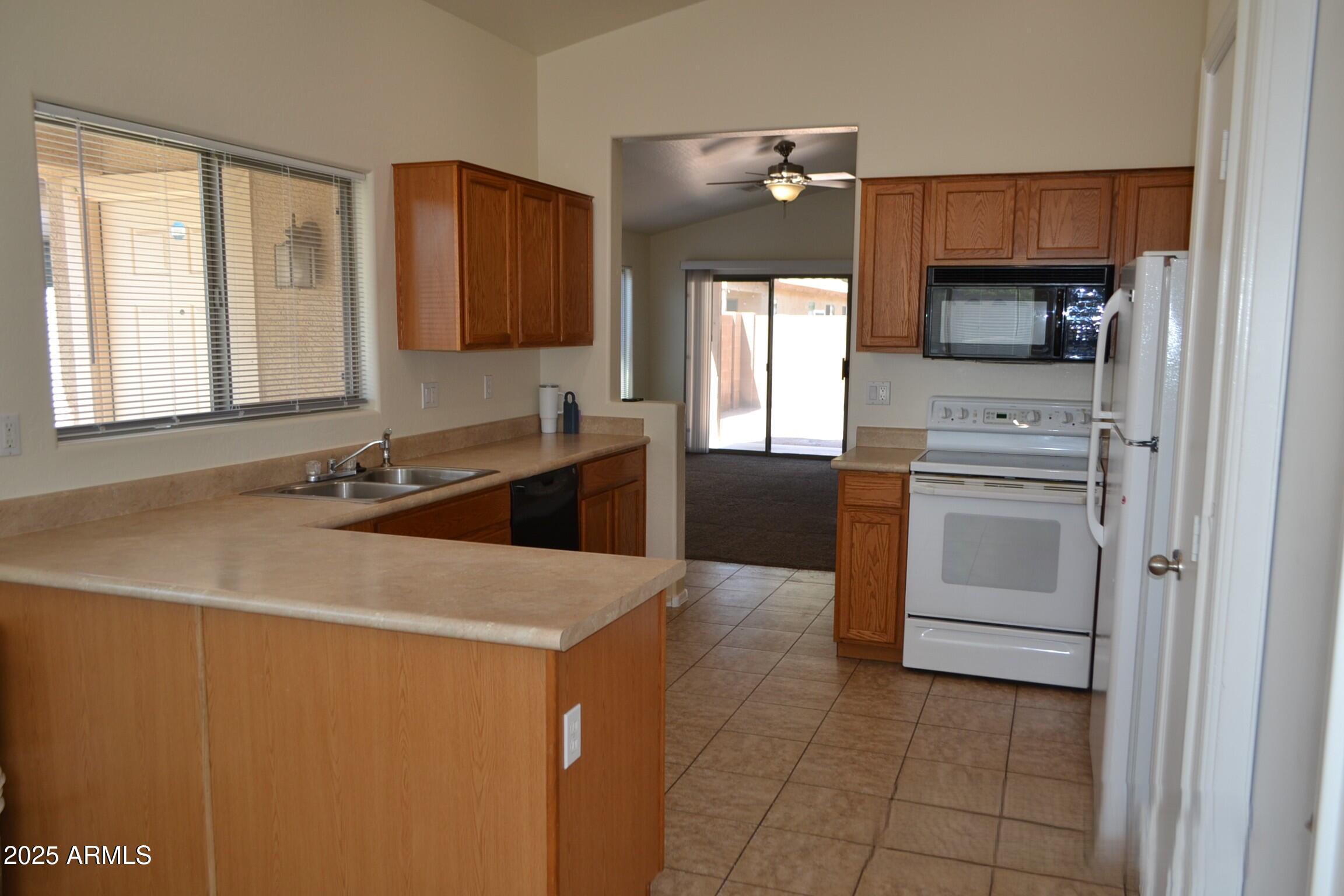 6746 East Superstition Way Florence, AZ 85132 - Photo 5 of 19 a kitchen with a sink cabinets and appliances