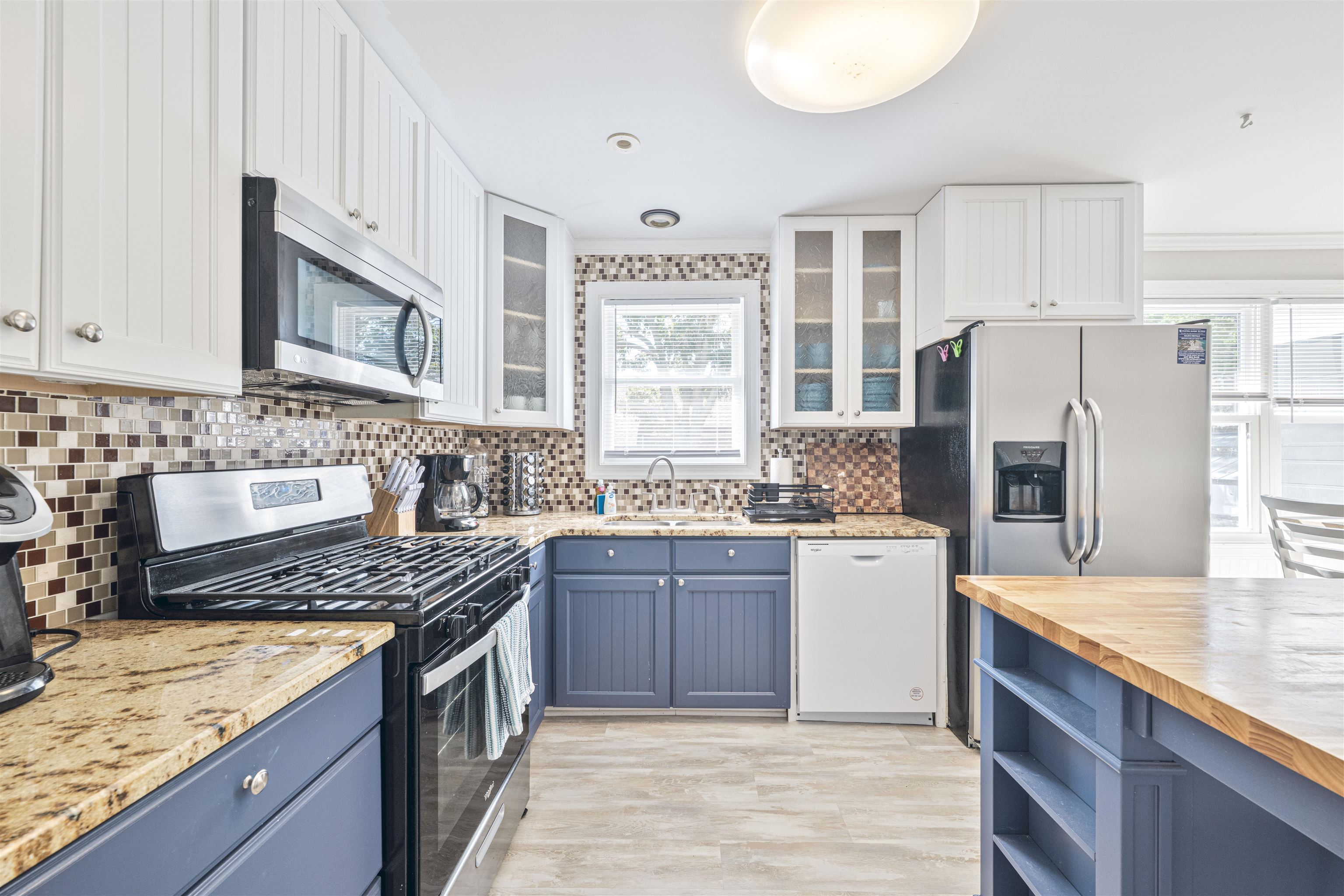 18 Pinewood Road Cape May, NJ 08204 - Photo 15 of 50 a kitchen with stainless steel appliances granite countertop a stove cabinets and refrigerator
