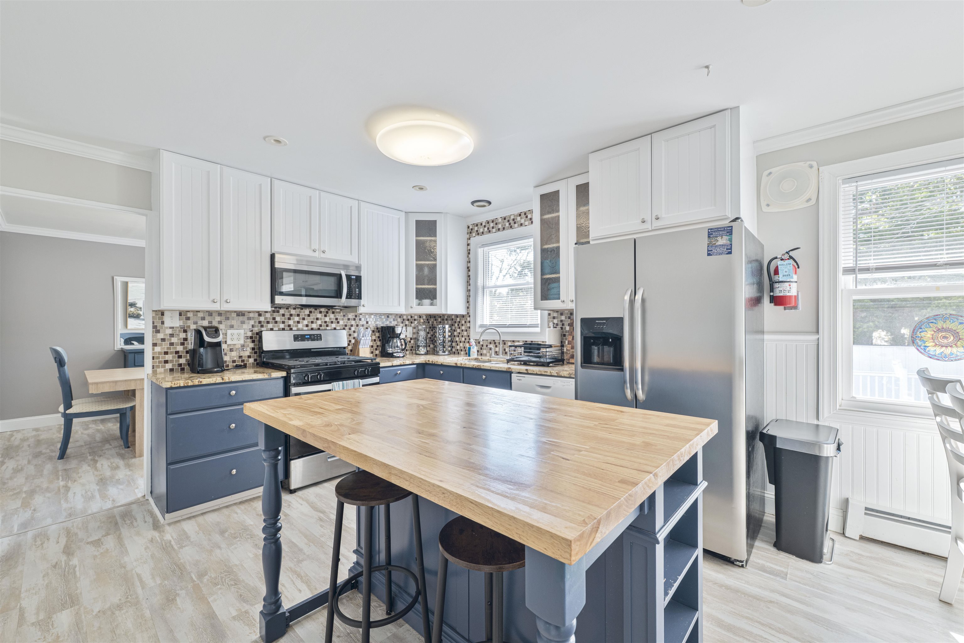 18 Pinewood Road Cape May, NJ 08204 - Photo 16 of 50 a kitchen with stainless steel appliances a table chairs refrigerator and microwave