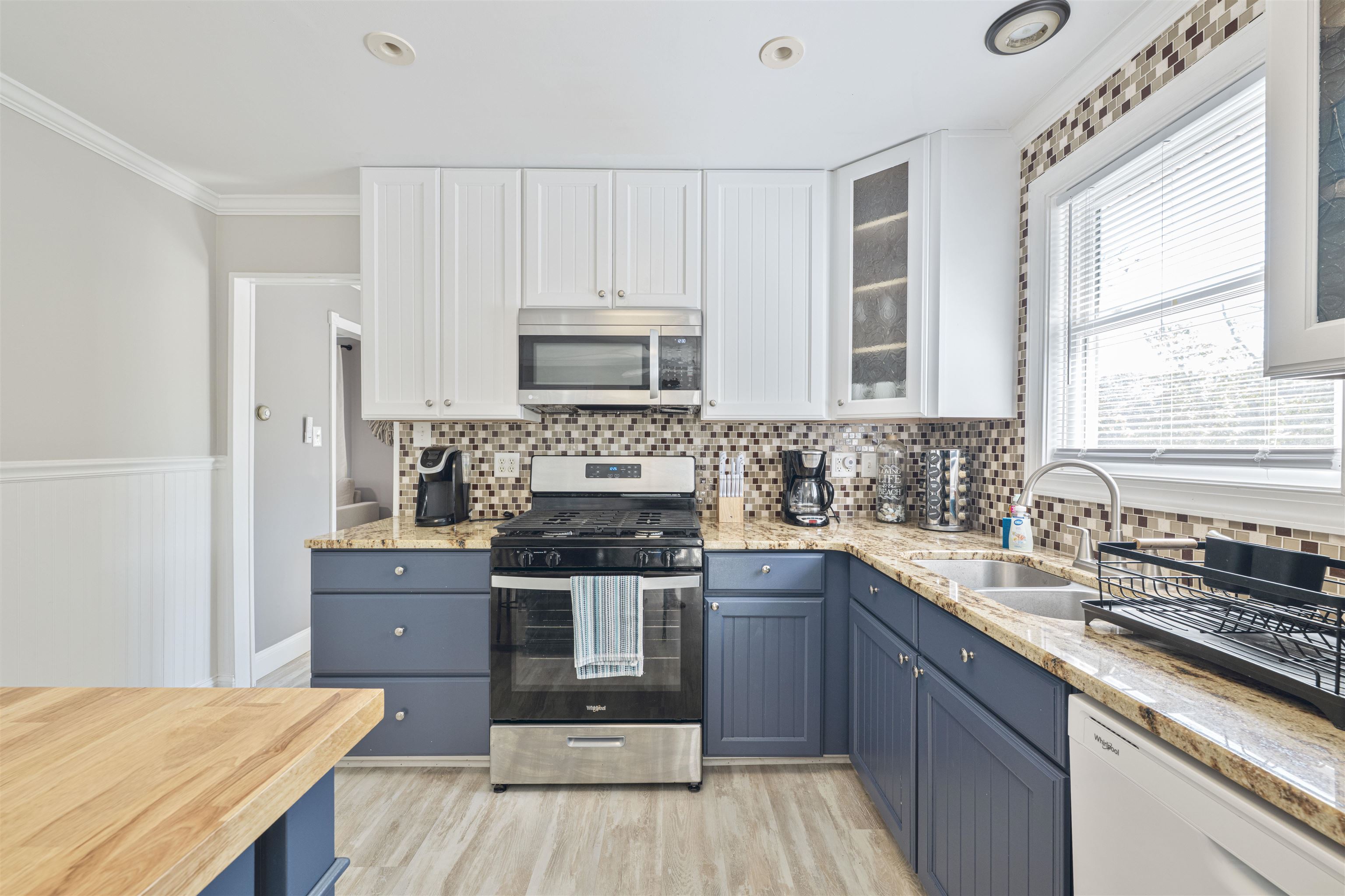 18 Pinewood Road Cape May, NJ 08204 - Photo 17 of 50 a kitchen with stainless steel appliances a sink a stove a refrigerator cabinets and a window