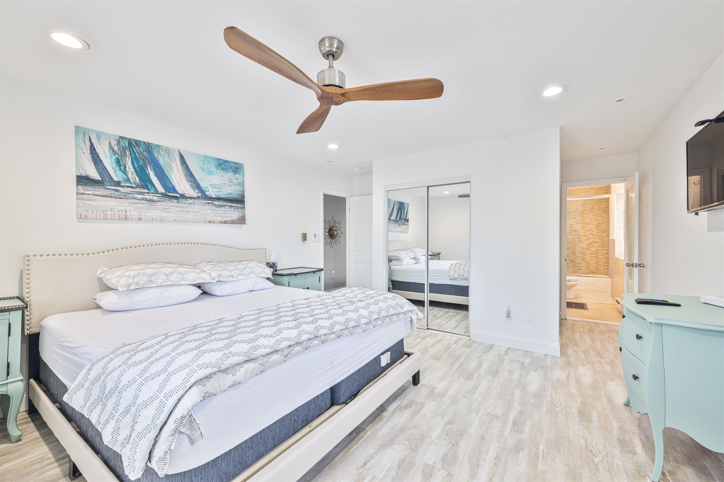 18 Pinewood Road Cape May, NJ 08204 - Photo 28 of 50 a bedroom with a large bed and a chandelier