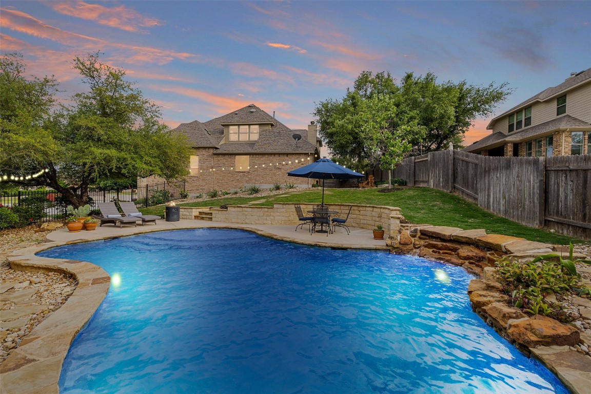 a view of a house with swimming pool yard and sitting area