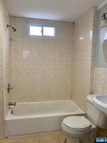 a bathroom with a toilet bathtub and shower