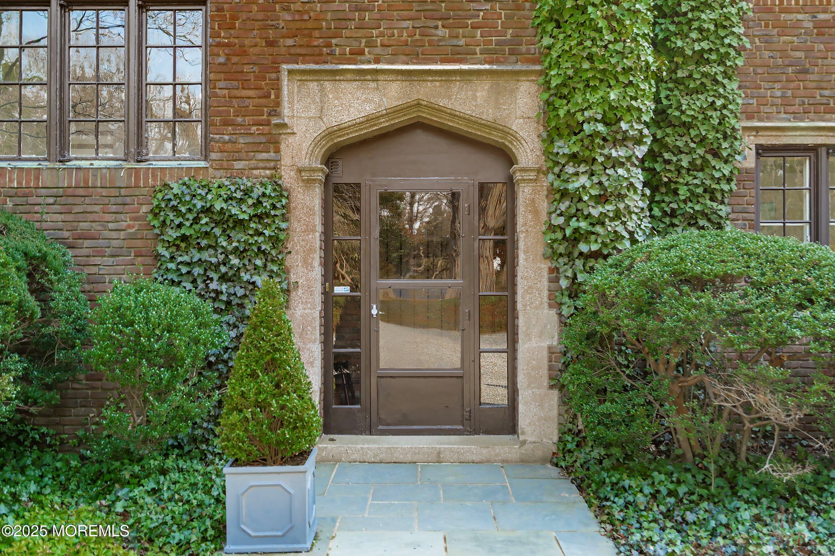 14 Fair Haven Road Rumson, NJ 07760 - Photo 8 of 51 a front view of a house with a glass door