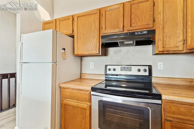 a kitchen with stainless steel appliances granite countertop a refrigerator stove and a sink