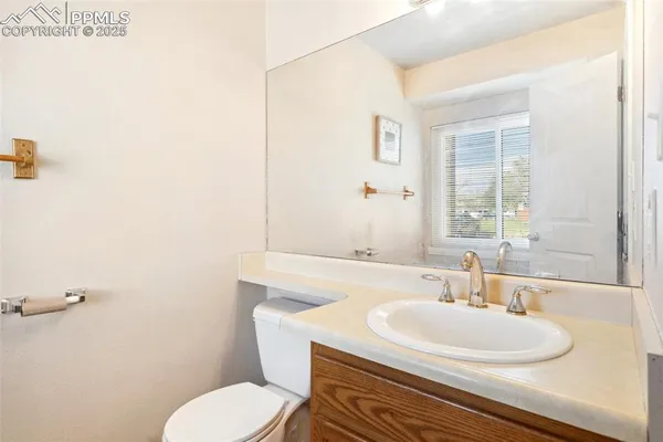 a bathroom with a sink toilet and mirror