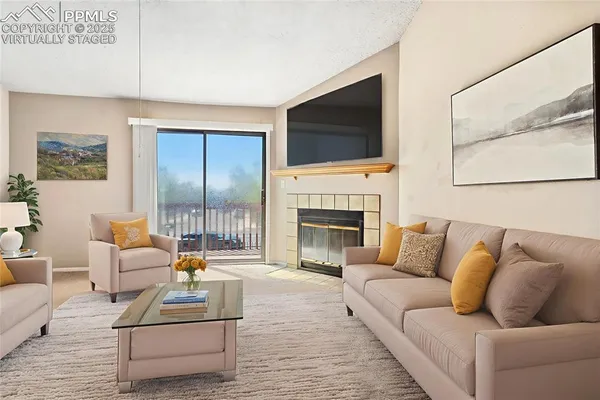 a living room with furniture fireplace and flat screen tv