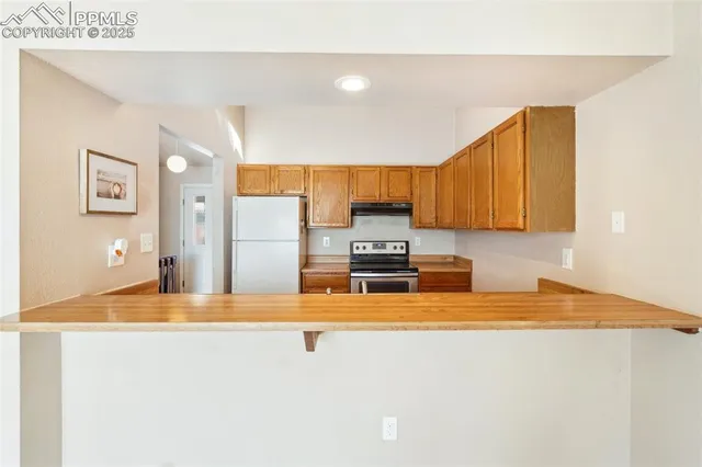 a kitchen with stainless steel appliances a refrigerator sink and stove